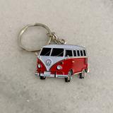 Red retro travel camper van metal keychain close up view