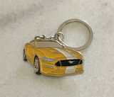 Yellow modern Ford Mustang metal sports car keyring close up