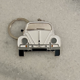 White retro bug metal car keychain close up view